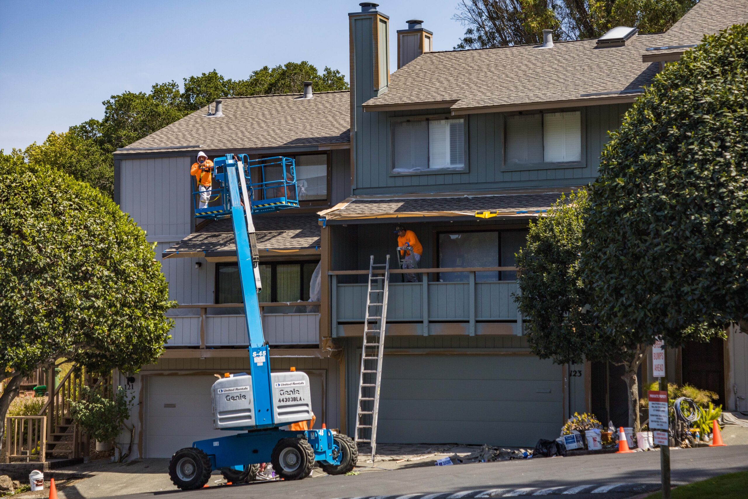 Exterior home project with crew working from a lift