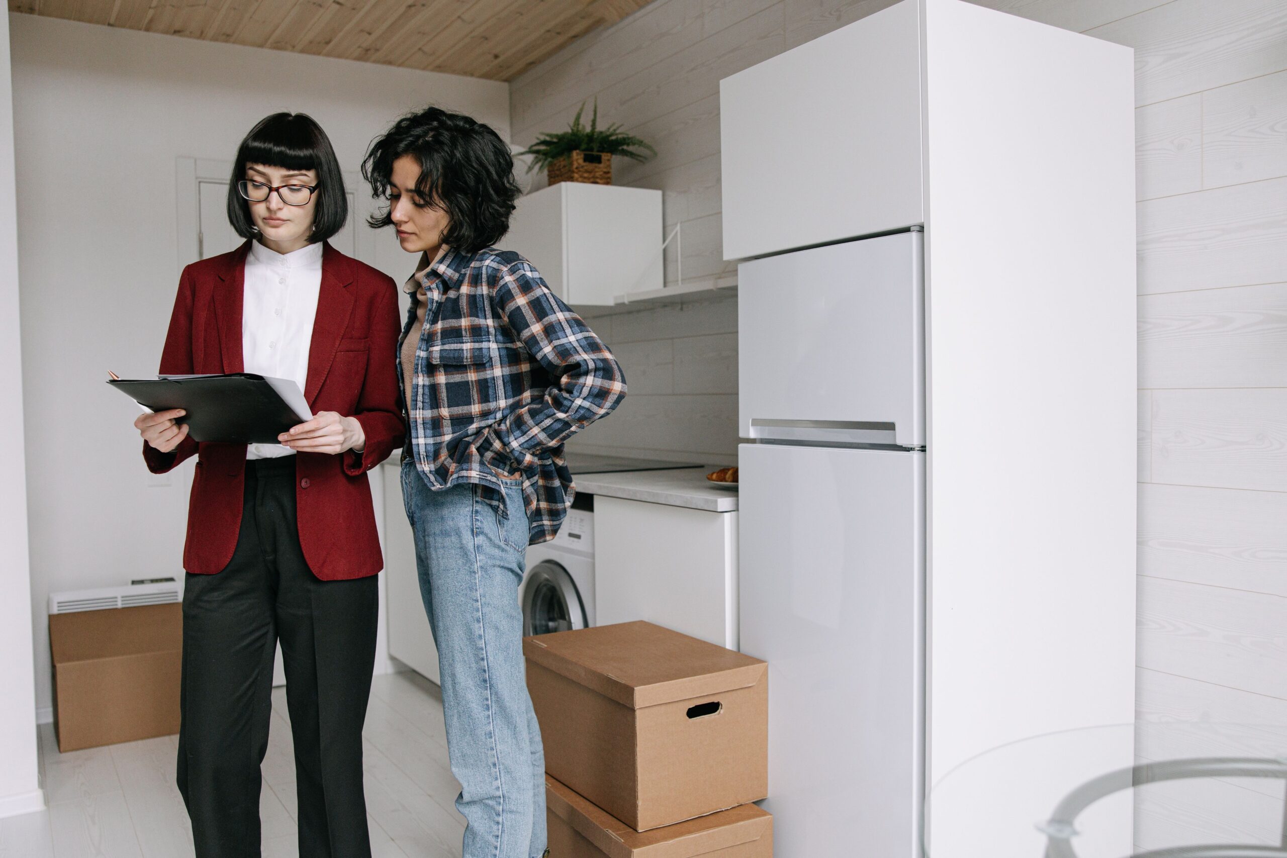 Homeowner reviewing a service checklist in a kitchen