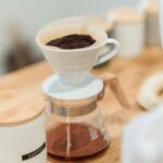 Ceramic dripper and glass carafe on a wooden counter