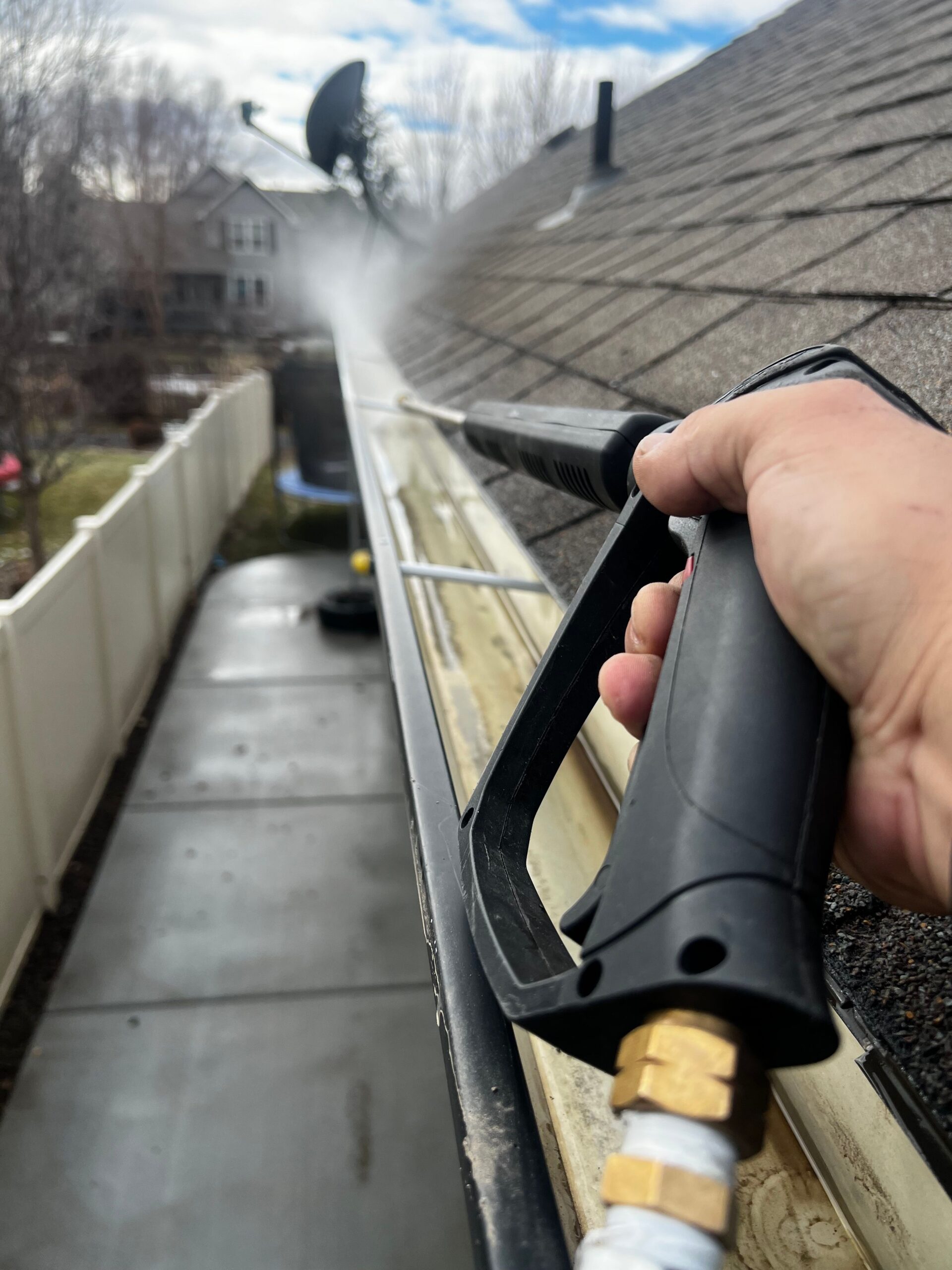 Pressure washing a residential gutter line