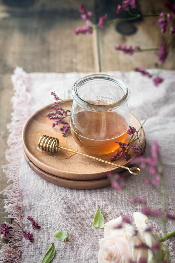 Artisan honey jar and dipper styled with flowers