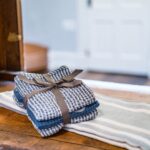 Rustic linen hand towels stacked on a wooden table
