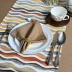Neutral table setting with a folded beige linen napkin