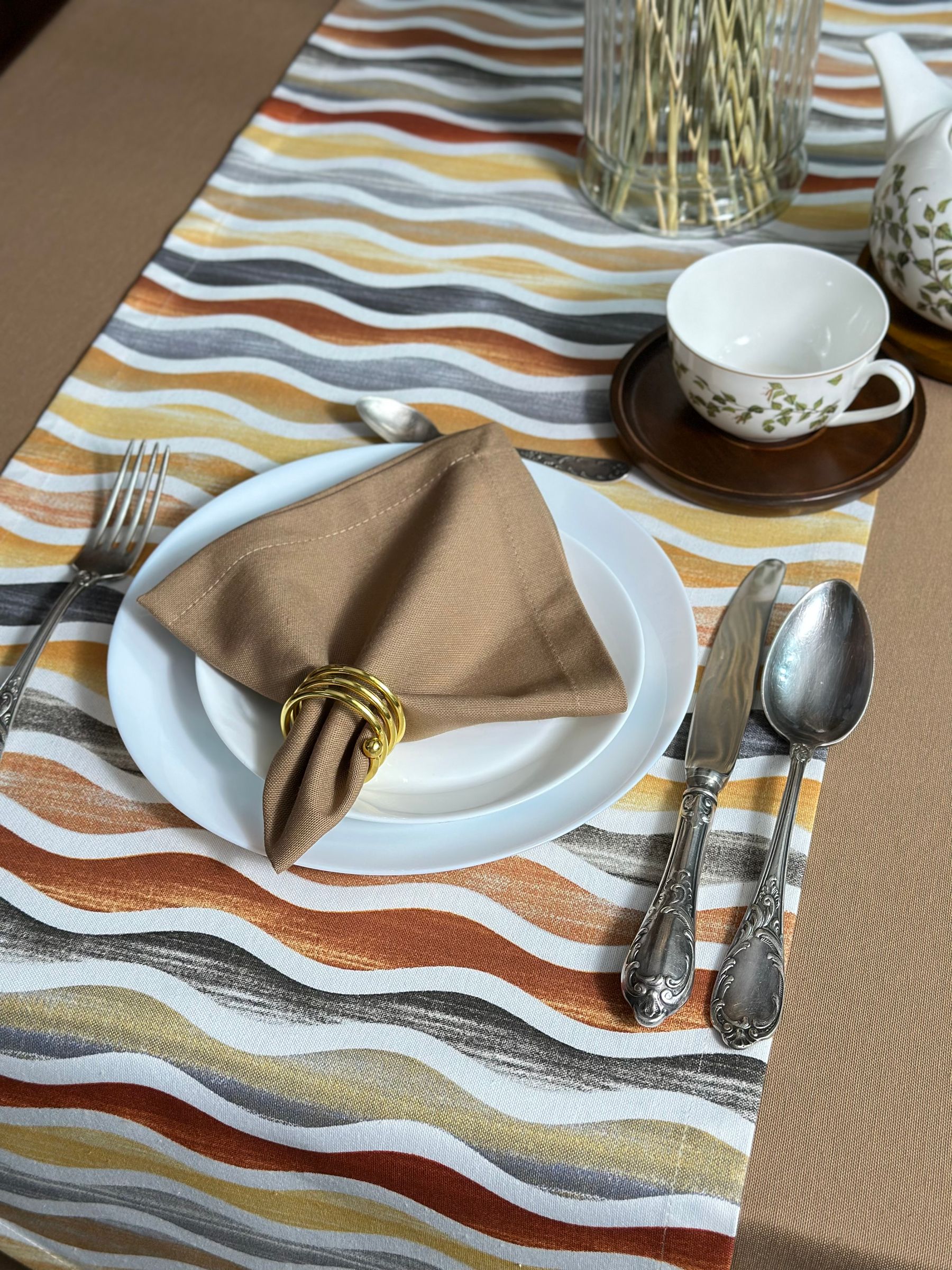 Neutral table setting with a folded beige linen napkin