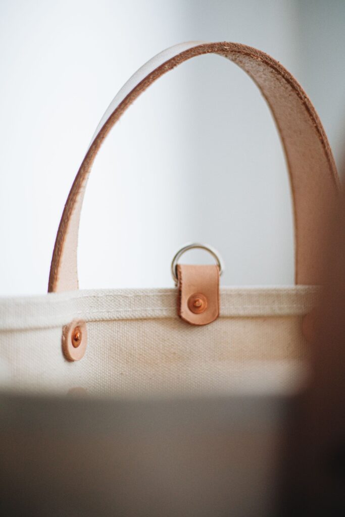 Close-up of canvas tote fabric and leather handles
