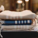 Folded neutral woven textiles in oat and blue stripes