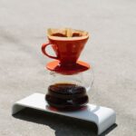 Minimal ceramic pour-over dripper on a glass carafe