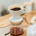Ceramic dripper and glass carafe on a wooden counter
