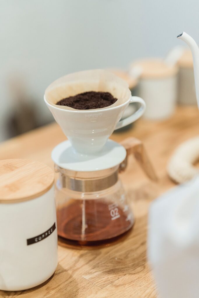 Ceramic dripper and glass carafe on a wooden counter